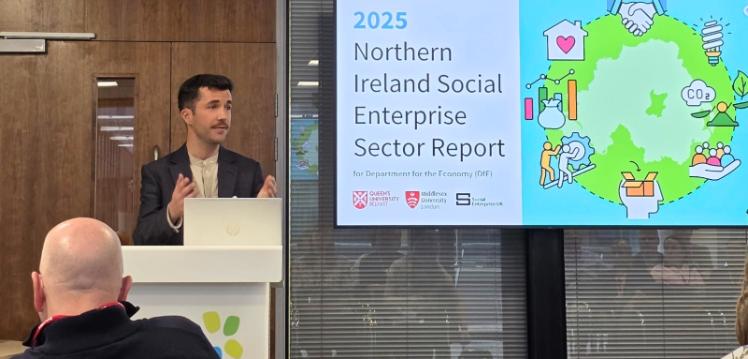 Chris presenting report to audience at Invest NI